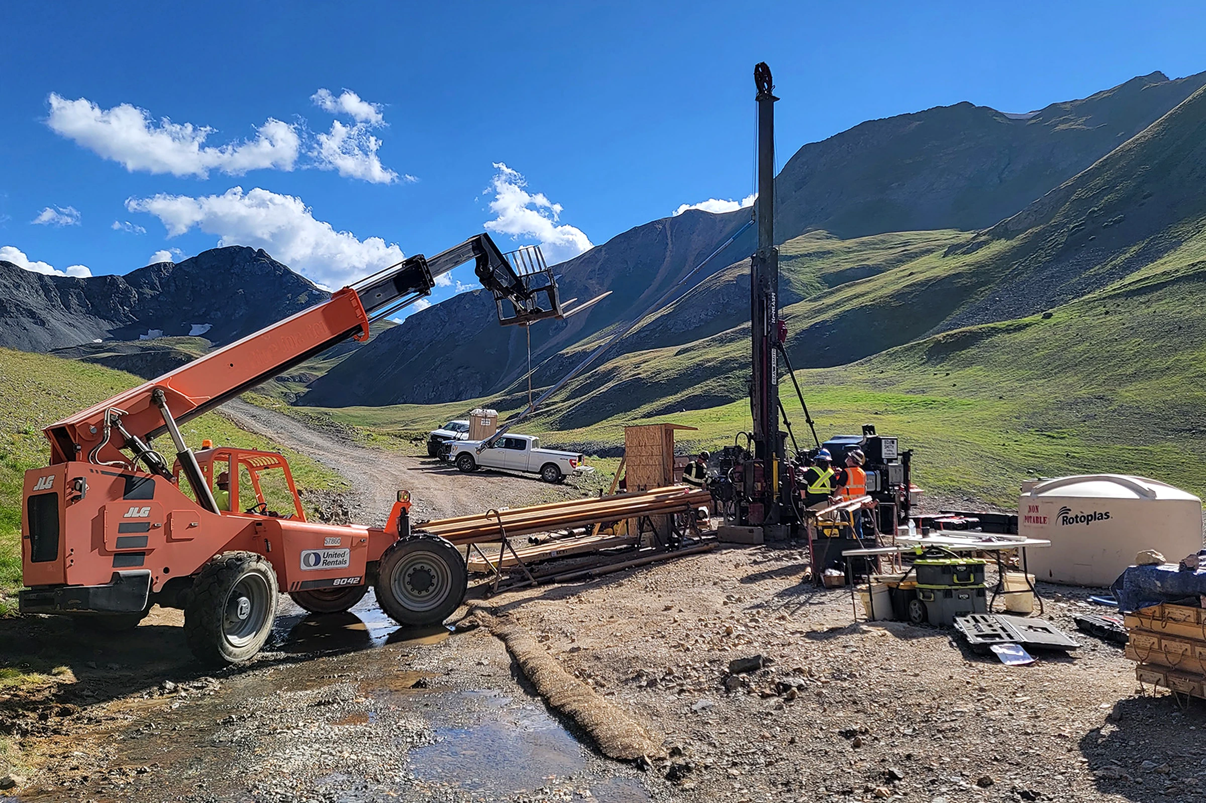 Surface drilling crew and equipment in an alpine valley